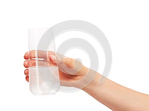 Hand holding drinking glass with tablet dissolving in water