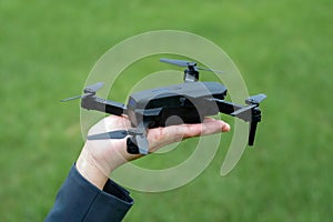 A hand holding a drone in the palm