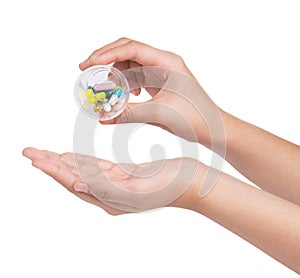 Hand holding Drug capsule on white background