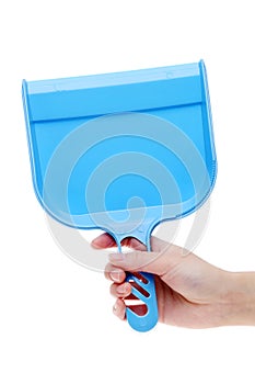 Hand holding dustpan