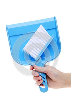 Hand holding dustpan