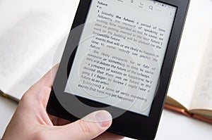 Hand holding ebook with text about future