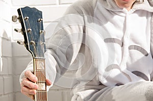 Hand holding electric guitar. People having fun. Music at home. Balcony. Girl with electric guitar