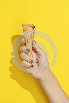 Hand holding empty ice cream cone