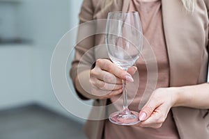 hand holding Empty wine glass  on white background