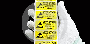 Hand holding ESD symbol label with antistatic gloves on black background,Electrostatic Sensitive Devices ESD in electronic