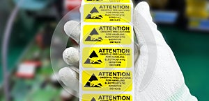 Hand holding ESD symbol label with antistatic gloves,Electrostatic Sensitive Devices ESD in electronic industrial