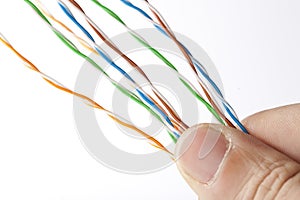 Hand holding ethernet cable wires