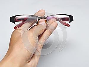 Hand holding eye glasses isolated