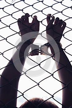 Hand holding fence