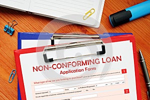Hand holding financial document with phrase NON-CONFORMING LOAN Application Form
