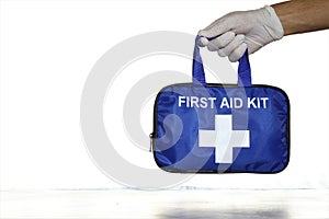 Hand holding a first aid kit bag.