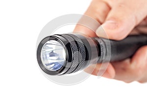 Hand holding flashlight on white background