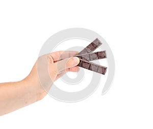 Hand holding foiled dark chocolate bars.