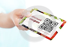 hand holding food discount coupon with qr code isolated over white