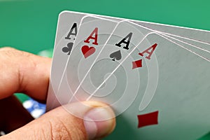 Hand holding four aces