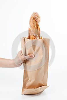 Hand holding a French baquette bread