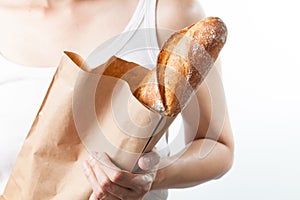 Hand holding a French baquette bread