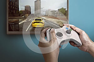 Hand holding game console controller playing game