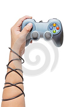 Hand holding game controller and tied up with cables