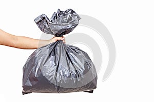 Hand holding garbage bag