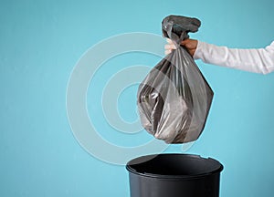 Hand holding garbage in plastic bag