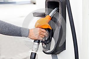 hand holding gas pump nozzle