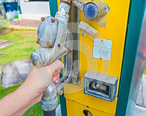 hand holding gasoline tap.