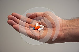 Hand holding generic drug pills