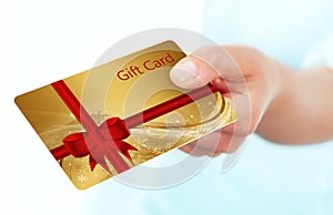 Hand holding gift card isolated over white