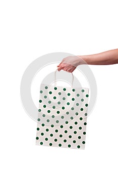 The hand holding giftbag on white