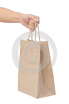 Hand holding and giving paper bag isolated over white background