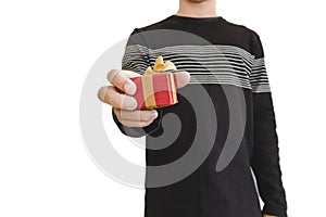 Hand holding, giving or receiving gift box, shallow depth of field, selective focus on gift box, isolated on white background