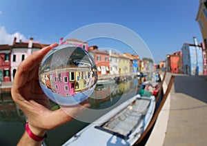 Hand holding the glass ball in the island of Burano near Venice
