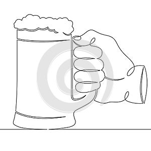 Hand holding a glass mug with beer foam