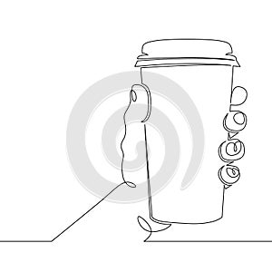 Hand holding a glass mug with hot coffee