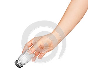 Hand holding a glass salt shaker