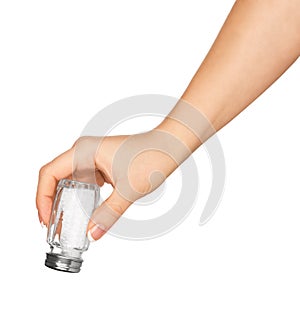 Hand holding a glass saltcellar with salt photo