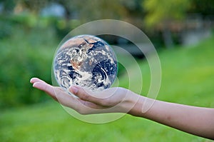 Hand holding a globe. Save Earth Environment