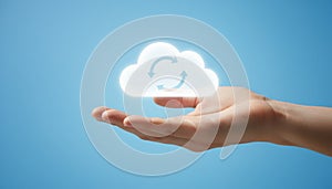 Hand holding glowing cloud synchronization icon for computing