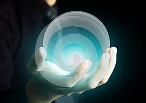 Hand holding a glowing crystal ball photo