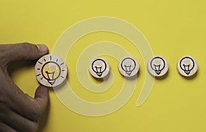 Hand holding glowing lightbulb move out from lamp icon for creative thinking idea innovation and problem solving solution concept