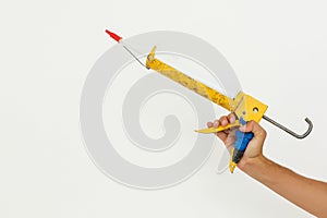 Hand holding glue gun isolated on the white background