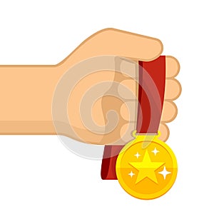 Hand holding golden medal with red ribbon