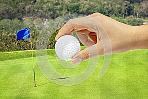 Hand holding golfball