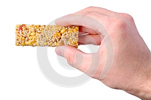 Hand holding granola bar isolated on white background