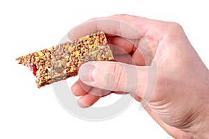 Hand holding granola bar isolated on white background