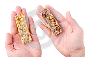 Hand holding granola bar isolated on white background