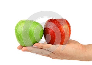 Hand holding green and red apples
