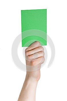Hand holding a green tag